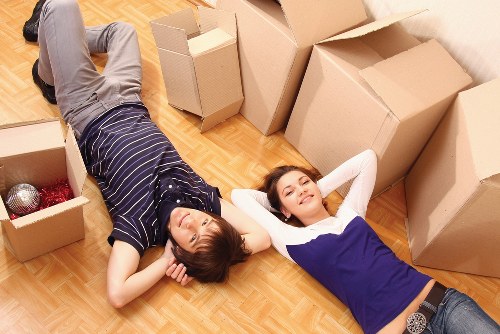 Professional movers packing office equipment